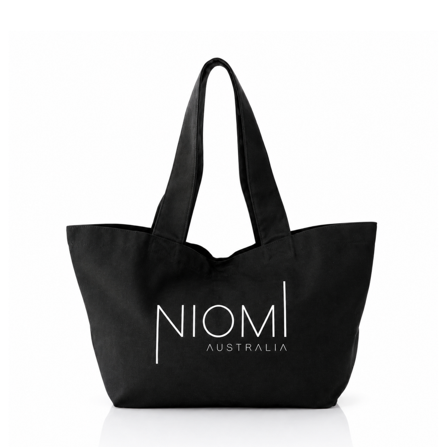 A black canvas tote bag with white printed text reading 'NIOMI AUSTRALIA' on the front, shown against a plain white background.