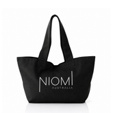 A black canvas tote bag with white printed text reading 'NIOMI AUSTRALIA' on the front, shown against a plain white background.