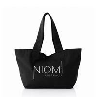 A black canvas tote bag with white printed text reading 'NIOMI AUSTRALIA' on the front, shown against a plain white background.