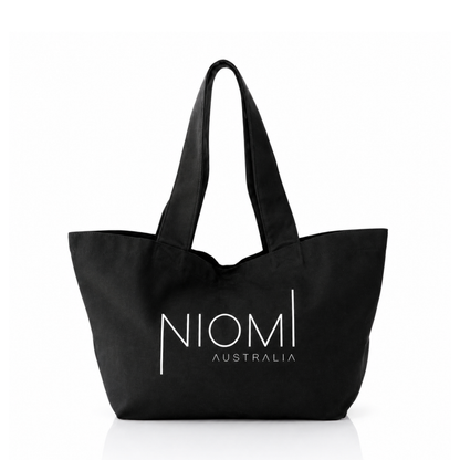A black canvas tote bag with white printed text reading 'NIOMI AUSTRALIA' on the front, shown against a plain white background.